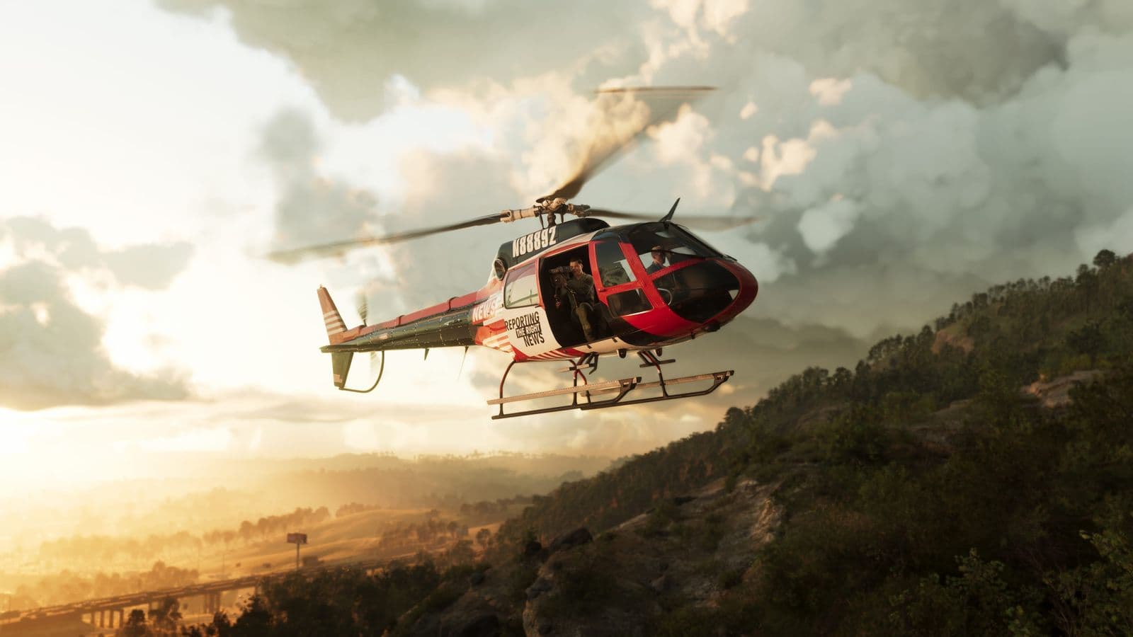 A news helicopter flying over a tree-covered ridge in Mount Kalaga National Park