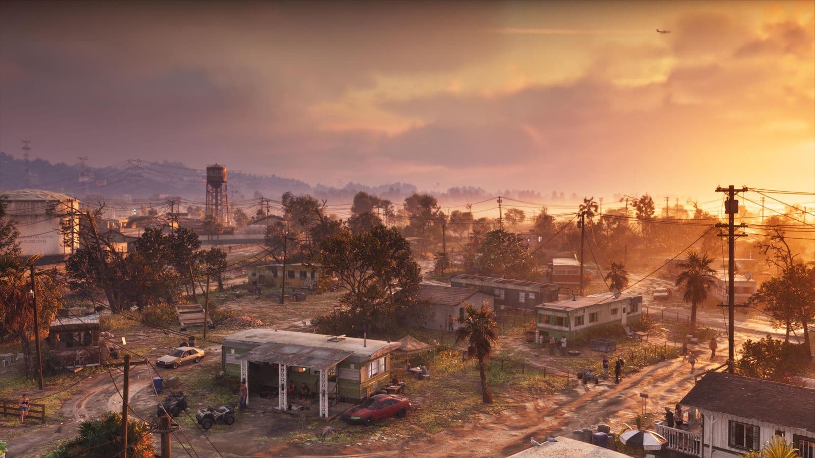 Port Gellhorn from above at sunset: low houses, a gas station and a water tower