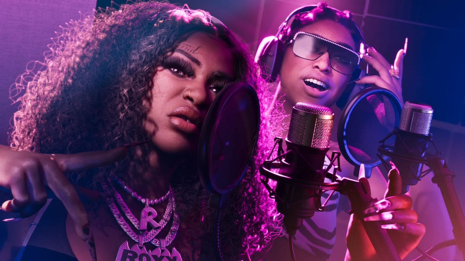Real Dimez, Bae-Luxe and Roxy, recording at a microphone in a studio